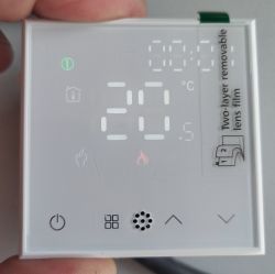 Thermostat control panel with lit temperature display showing 25°C and touch icons