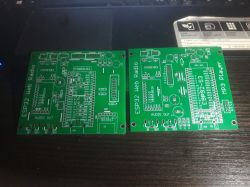 Two green ESP32 Web Radio PCBs with labeled connectors and component footprints on a desk