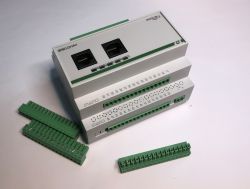 Building automation controller on a white background with two network ports and green terminal blocks.