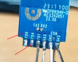 Close-up of a board with pin labels, with two arrows pointing to pins P26 and P24.