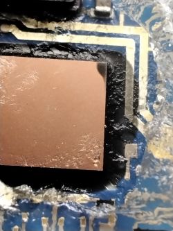 Close-up of a circuit board with a burnt area.