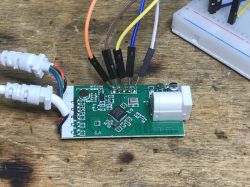 Interior of LED Strip Controller with WiFi PCB of LED controller with connected wires for testing.