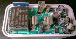 Interior of a smart plug with electronic components on a PCB.