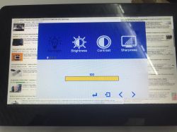Monitor screen showing settings menu: Brightness, Contrast, Sharpness, with slider set to 100
