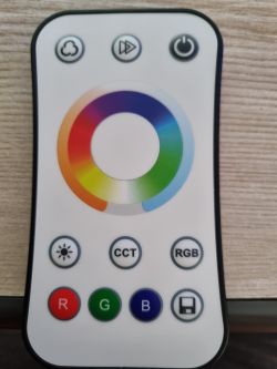 Remote control with a color ring for light adjustment and function buttons.
