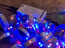 Miboxer FUT037W+ LED Controller with Colorful LED Strips Miboxer FUT037W+ LED controller with connected light strips displaying various colors.