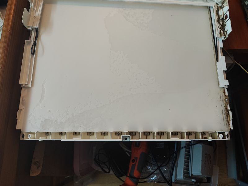 Plastic Frame of Flood-Damaged TV Lower part of the plastic frame of a flood-damaged TV with visible sediment and dirt.