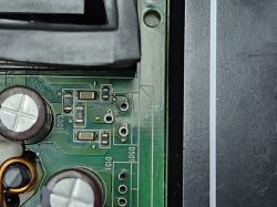 Section of a PCB with SMD and through-hole components Close-up of a PCB with capacitors and SMD components