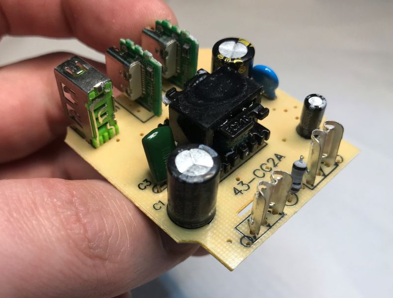Close-up of power supply PCB with electronic components and USB ports