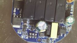 Close-up of an electronic module with relays, capacitors, and an inductor.