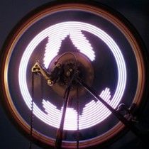 Round LED panel with concentric light rings, front view with mounting parts in the center