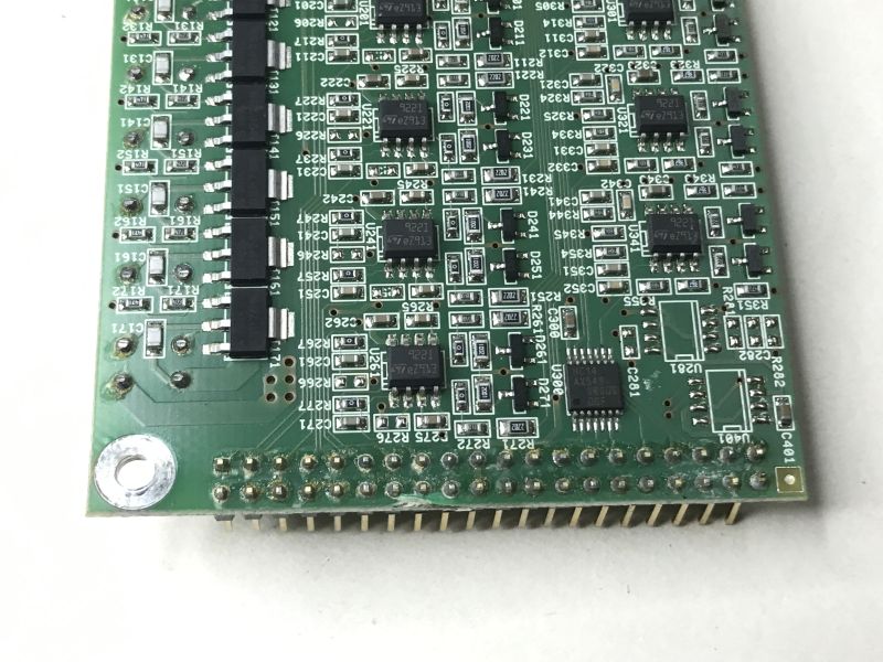 Close-up of the lower part of a green PCB with multiple ICs and a pin header