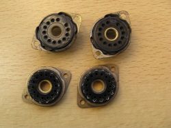 Four tarnished DL-531 vacuum tube sockets on a wooden surface.