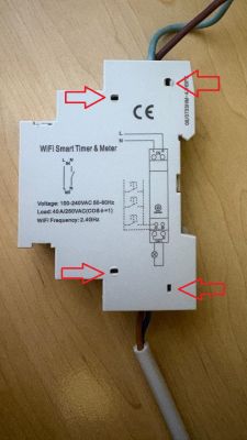 White “WiFi Smart Timer &amp; Meter” module on a table, with red arrows pointing at small openings