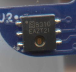 Close-up of S3310 integrated circuit on a blue PCB with three leads on each side