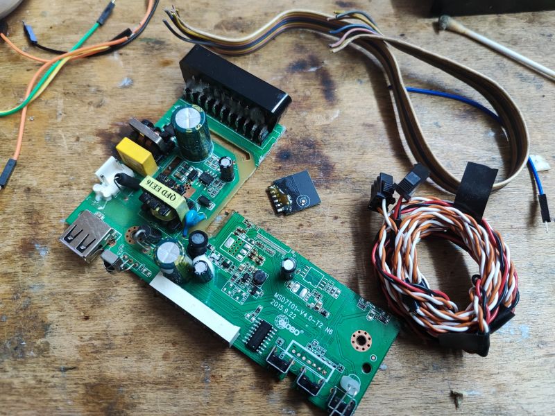 Modification of Satellite Tuner Board into a Development Board Modified satellite tuner board with electronic components and cables.