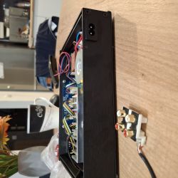 Interior view of electronic device housing with wires and RCA connectors