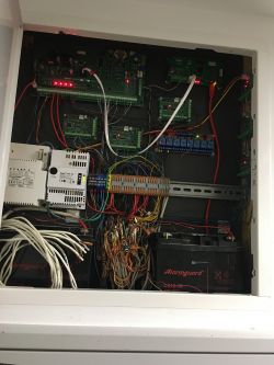 Interior of an electrical cabinet with controllers and wiring.