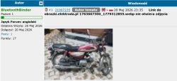 Forum screenshot showing a post with an embedded photo of a red-and-black motorcycle indoors