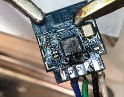 Close-up of an electronic circuit with soldered wires.