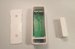 Photo of an open door sensor casing showing the circuit board.