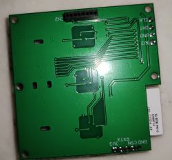 Printed Circuit Board of Control Module Green printed circuit board with visible traces and a connector at the top.