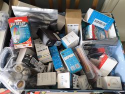 Collection of Electronic Devices in a Box A box full of various electronic devices, including smart bulbs, sensors, and cables.