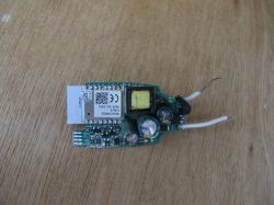 Electronic module with components on a wooden surface.