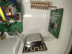 CC1101 and ESP8266 Integration in Smart Socket CC1101 and ESP8266 modules soldered inside a socket housing, connected by thin wires.