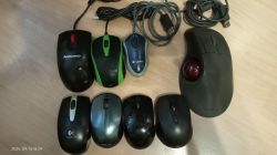 A collection of various computer mice, including one large with a trackball.