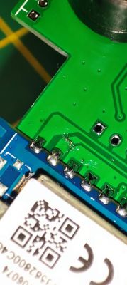 Close-up of a circuit board with visible pins and soldering marks.