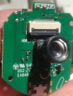 Close-up of a circuit board from an A9 webcam with visible lens and ribbon connector.