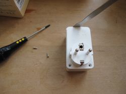 LoraTap SP800WJ-EU - Smart Plug Disassembly LoraTap Tuya smart plug with open case and tools on a white background.
