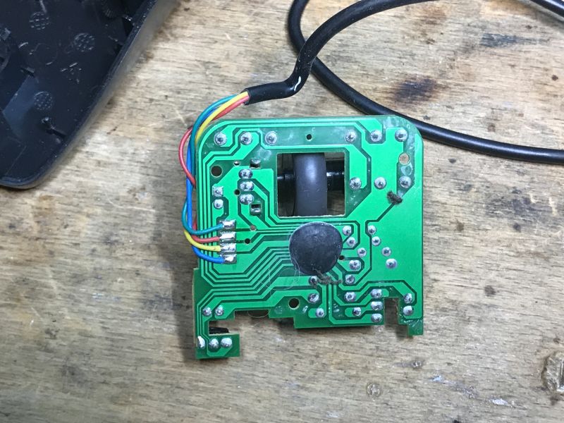 Interior of an Old Computer Mouse with Circuit Board Interior of an old computer mouse with visible circuit board and wiring.