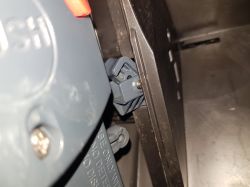 Zbliżenie na wewnętrzny mechanizm ekspresu do kawy DeLonghi z widocznym elementem plastikowym