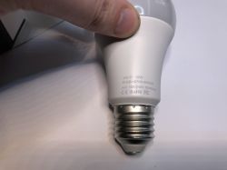 Wi-Fi enabled LED bulb held in a hand.