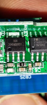 Close-up of a circuit board with two integrated circuits and markings.