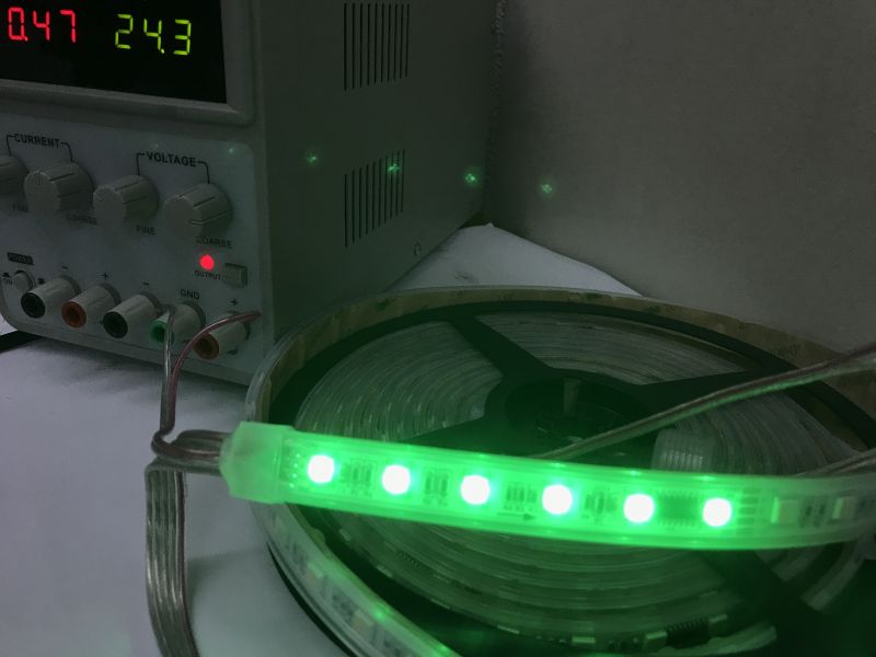 RGBW LED strip with TM512 driver and wiring for power and data RGBW LED strip model HR00-C24RGBW512AC4-60 divided into sections of six LEDs, each controlled by a TM512 chip, with visible power and signal wires.