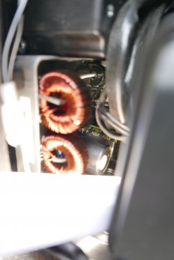 Inside a Generator Inverter Internal view of a generator inverter showing coils and capacitors.