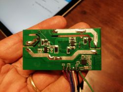 Circuit board inside a Sonoff enclosure with relay circuitry.