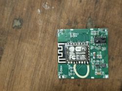 ESP8266 Wi-Fi module on a PCB placed on a wooden surface