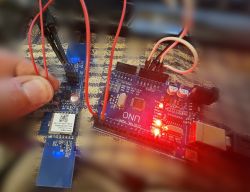 GPS Module Connected to Arduino UNO Board GPS module connected to Arduino UNO board with wires on a fabric-covered surface