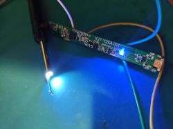 Illuminated electronic circuit board with connected wires and glowing LED light