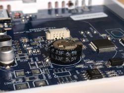 Supercapacitor on Thermostat Circuit Board Close-up of a circuit board with a 0.33F 5.5V supercapacitor.