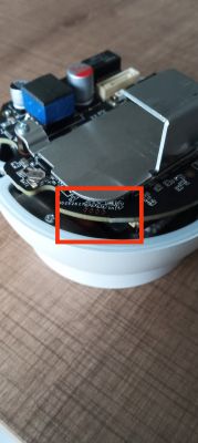 Zbliżenie na wnętrze urządzenia elektronicznego z podkreślonymi pinami na płytce drukowanej.