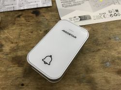 Aigostar Wireless Doorbell Aigostar wireless doorbell on a table with instructions in the background