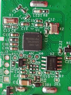 Close-up of a circuit board with a visible OPL1000 chip.