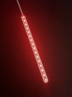LED strip emitting red light on a dark background.