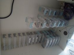 Shelves with transparent containers for small electronic components