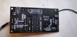 Płytka układu elektronicznego z widocznymi napisami i punktami lutowniczymi.